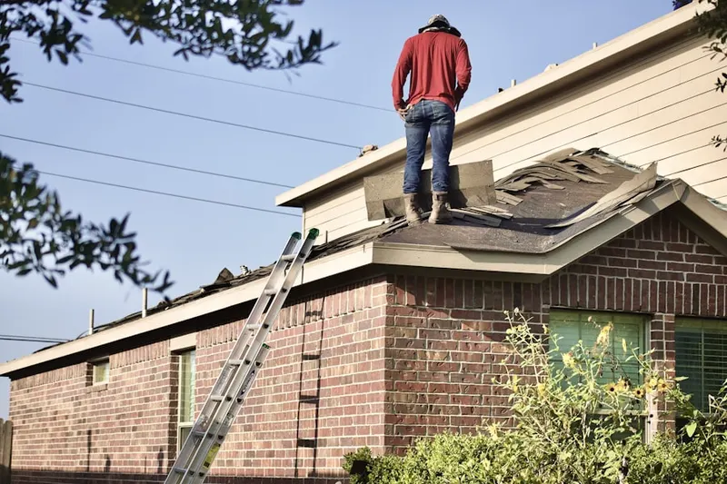 Professional roofer working on a residential roof in Mableton